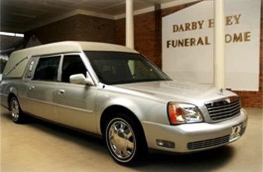 Silver hearse parked outside 