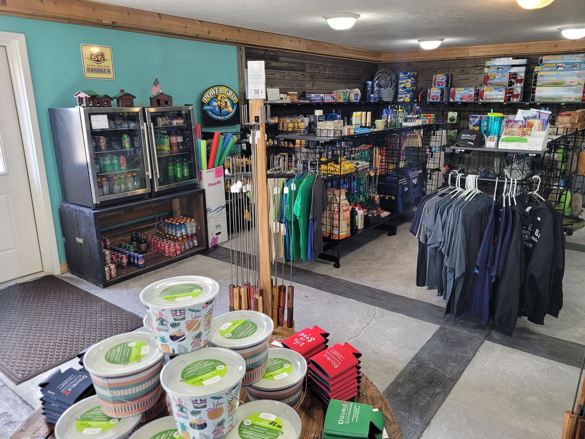 A store filled with lots of items including t-shirts and bowls.