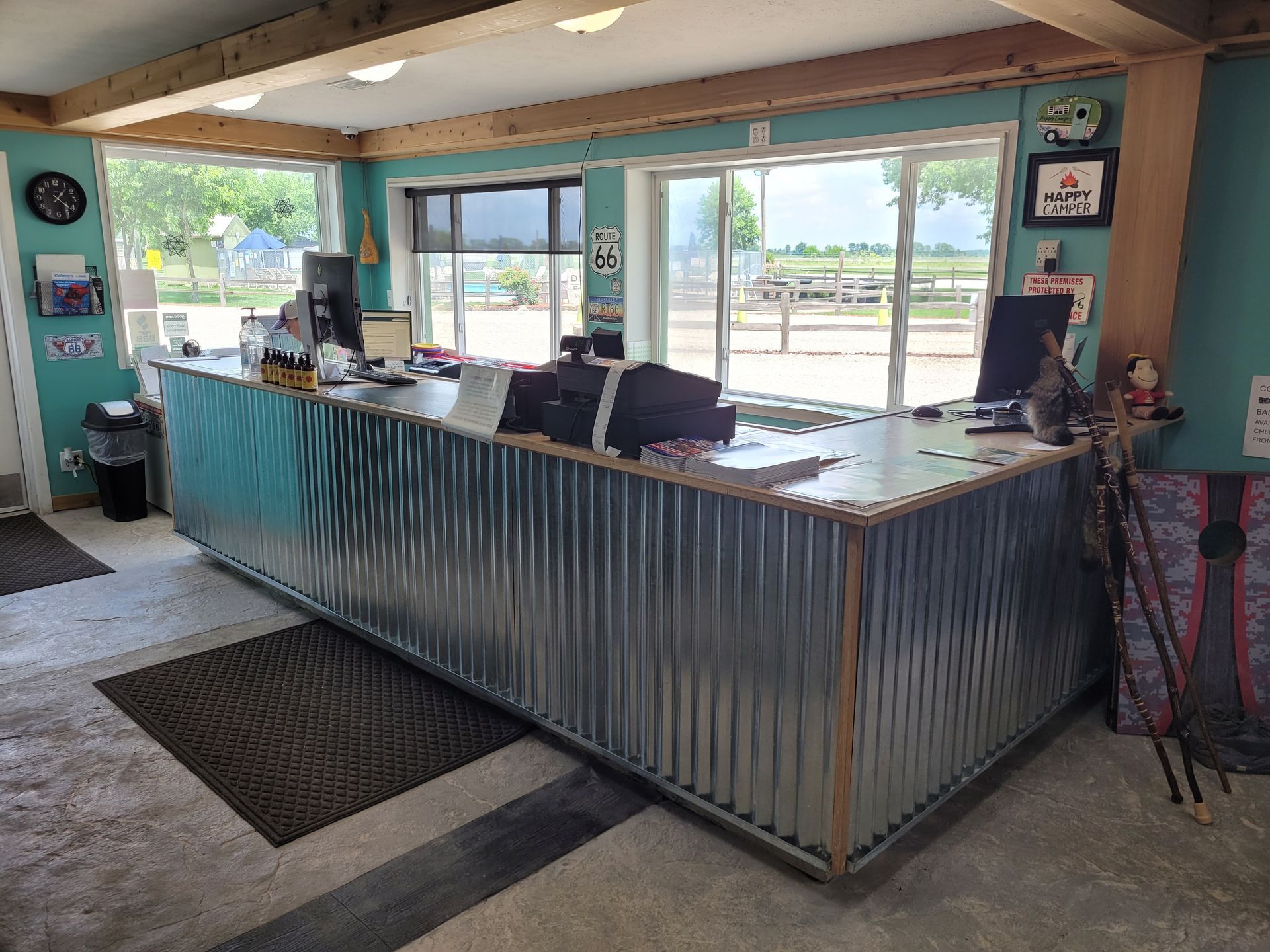 A long metal counter in a room with a lot of windows.