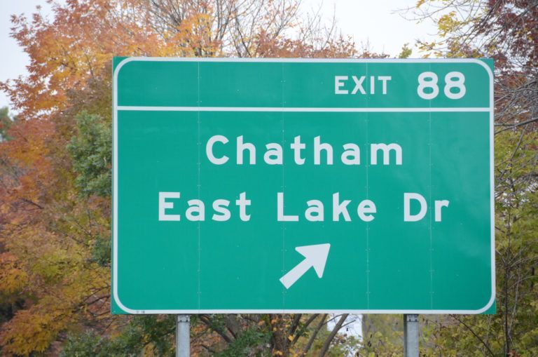 A green sign that says exit 88 chatham east lake dr