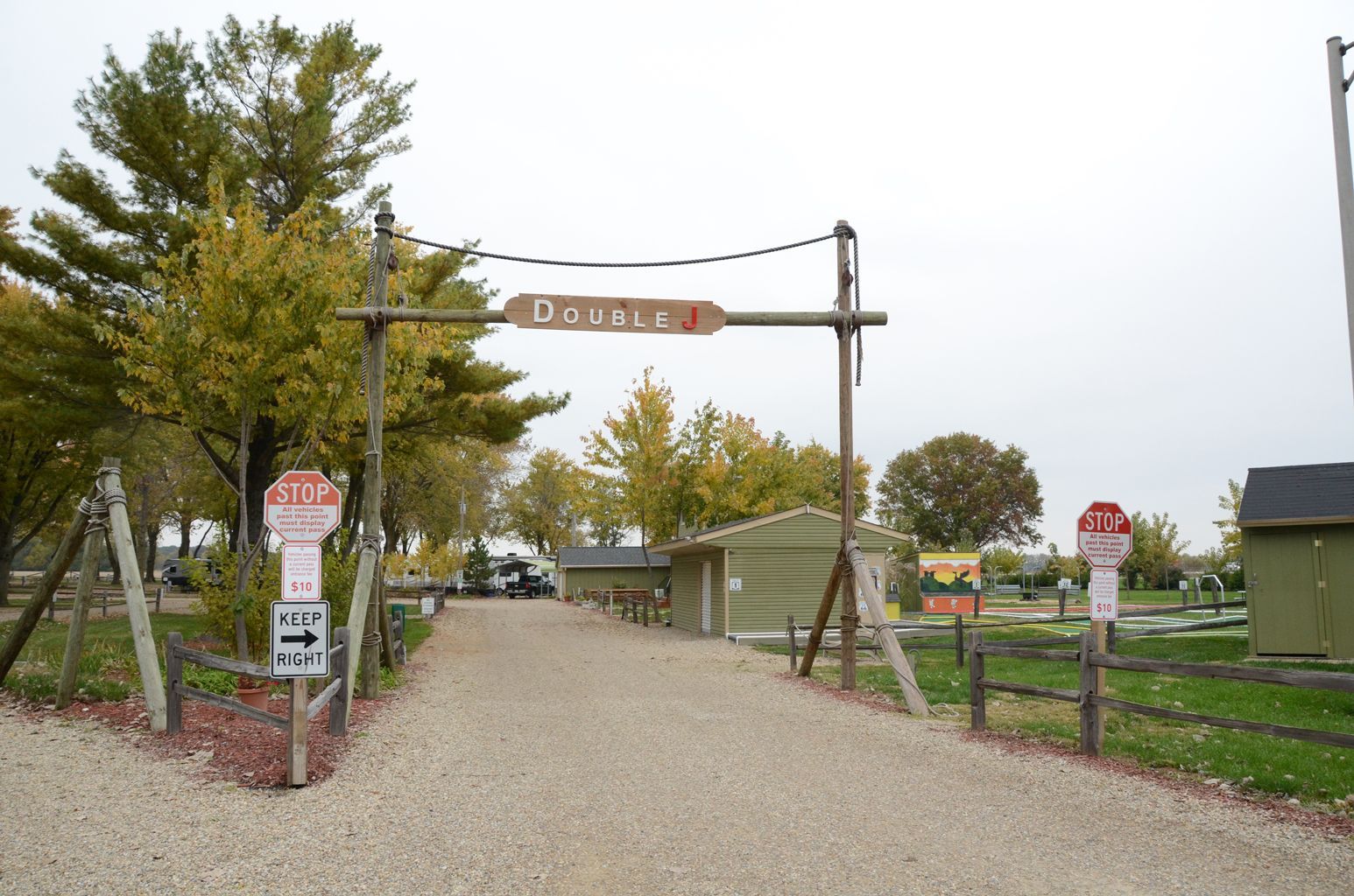 A gravel road with a sign that says do not enter