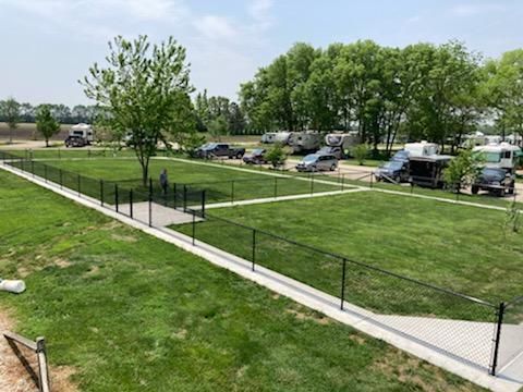 A fenced in area with a lot of vehicles parked in it.