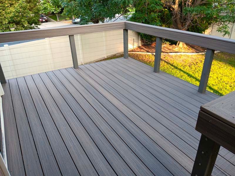 A wooden deck with a wooden railing 