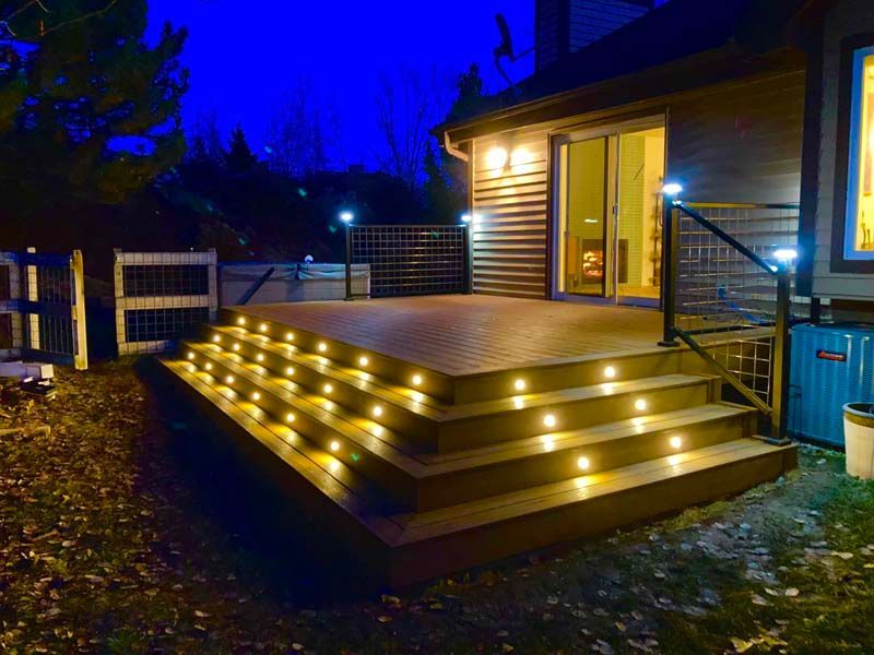 A deck with stairs and lights