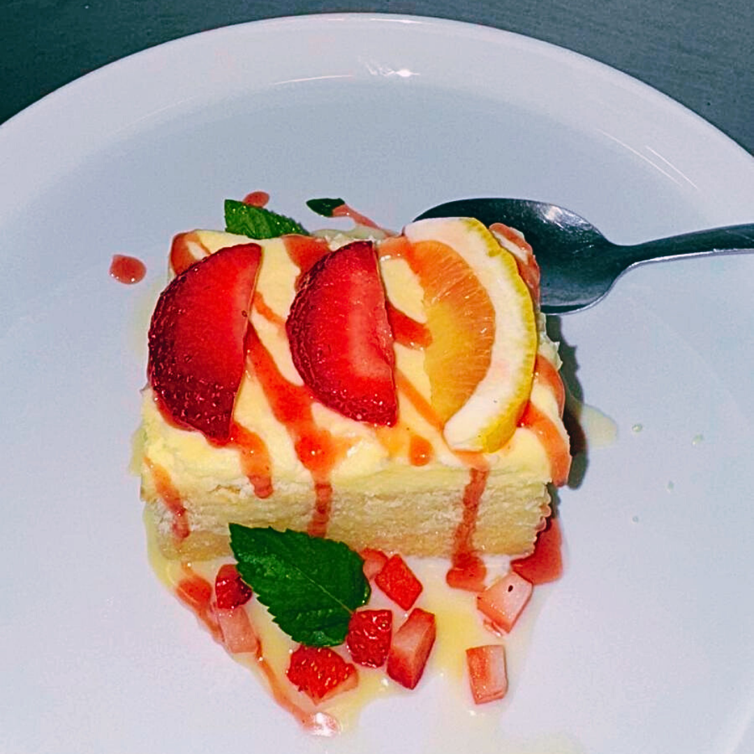 Lemon tres leches cake dessert topped with fresh fruit at Fiesta Charra Eastwood