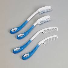 Four blue and white long-handled hair care aids: two brushes and two combs, designed for people with limited reach.