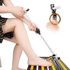 Woman using a sock aid to put on a sock.