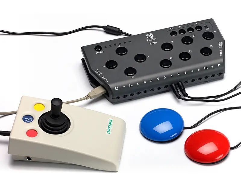 Assistive technology: joystick and buttons connected to a gray interface box for use with a Switch.