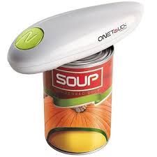 Electric can opener opening a can of soup; white opener with green button, soup can with pumpkin image.