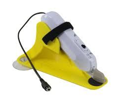 Yellow stand holding a white device with a black strap and cord.