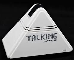White, pyramid-shaped talking alarm clock with black accents, label reads 