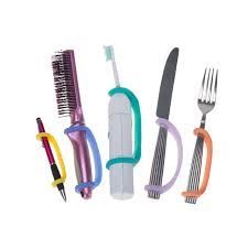 Adaptive eating utensils and grooming tools with attached hand straps, for those with limited grip.