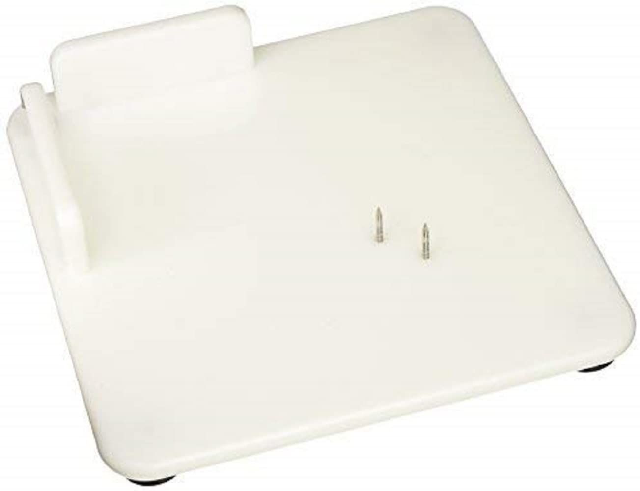 White plastic cutting board with raised walls and two pins.