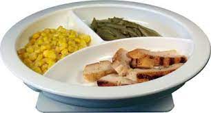 Divided white plate with corn, green beans, and sliced meat.