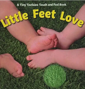Two pairs of baby feet on green grass, one touching a grassy ball. The book cover says 