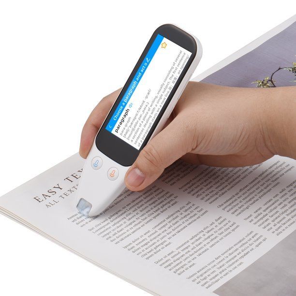 Person holding a white text scanner over a newspaper, the screen displays scanned text.