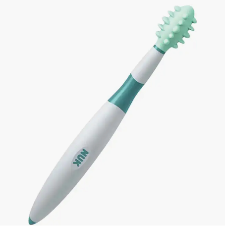 Baby toothbrush with textured green bristles and white handle.