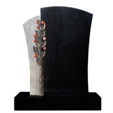 Ein schwarzer Grabstein mit einem Baum und Blättern darauf.