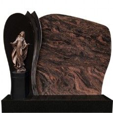 Ein Grabstein mit einer Jesusstatue darauf.