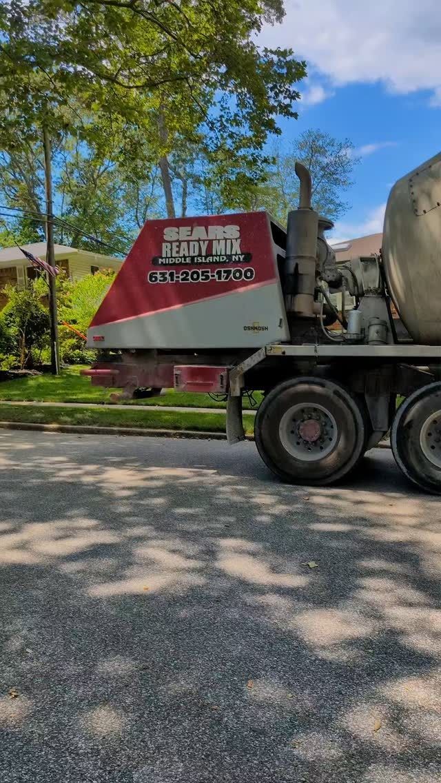 A concrete pump truck is parked on the side of the road.
