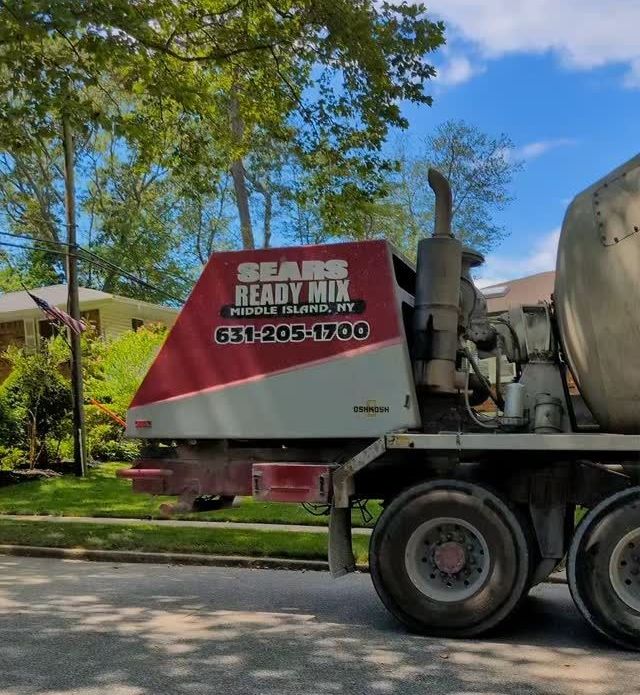 A sears ready mix truck is parked on the side of the road