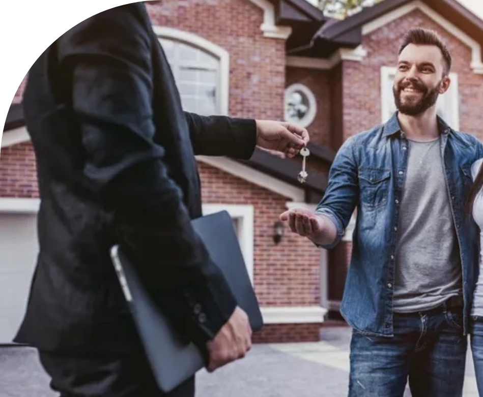 A new couple being handed the keys to their new home. 