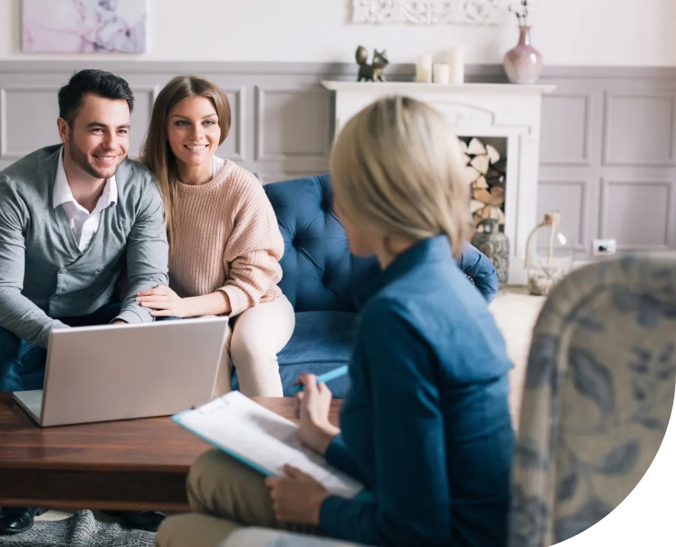 A man and woman working with a real estate agent. 