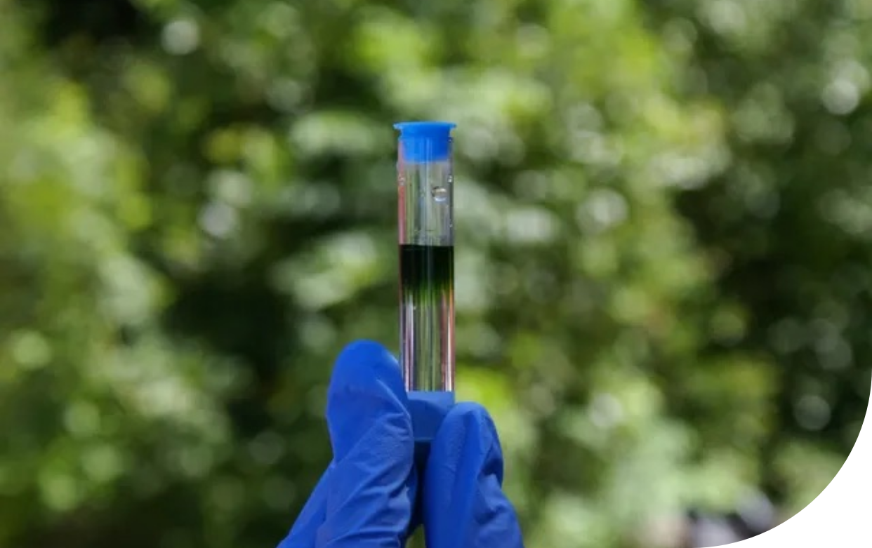 A blue-capped test tube is being inspected. 