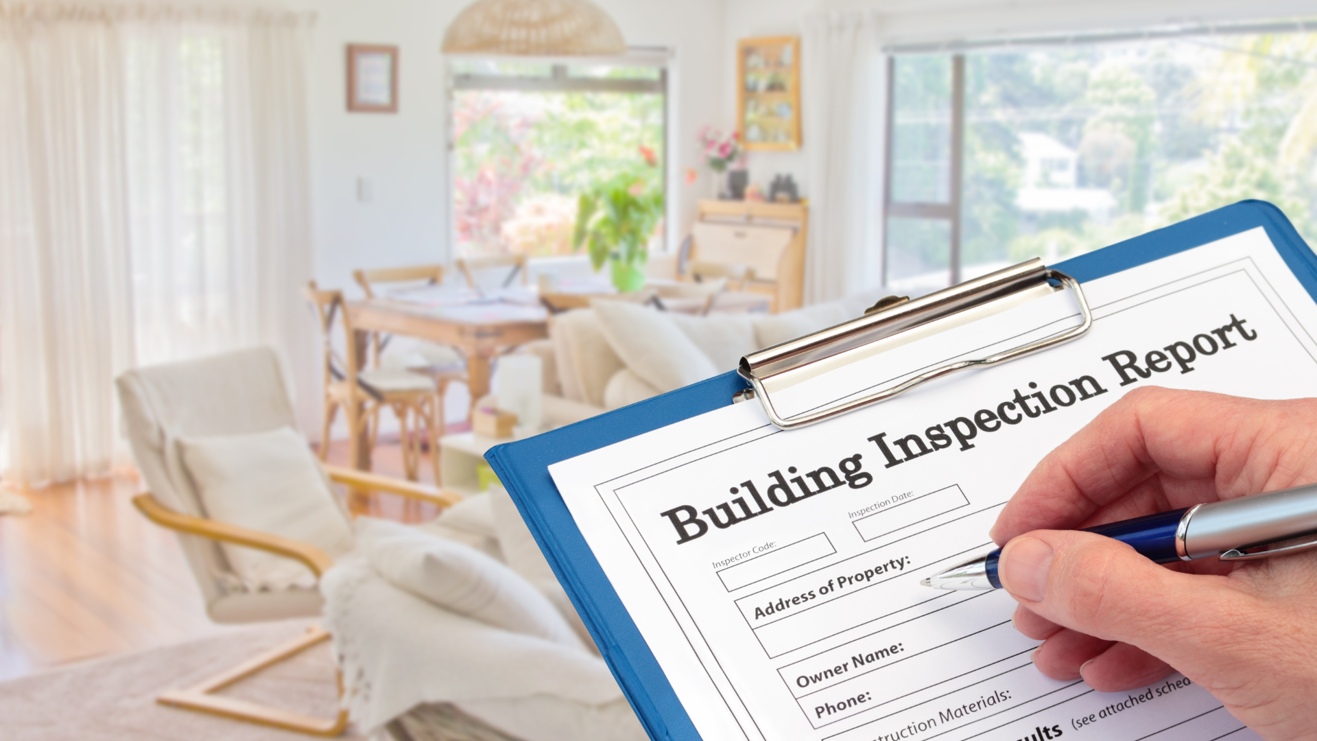 A person is writing a home inspection report on a clipboard.
