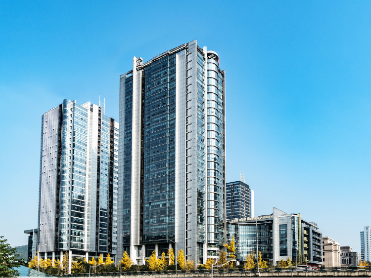 A city street with a lot of traffic and buildings in the background.