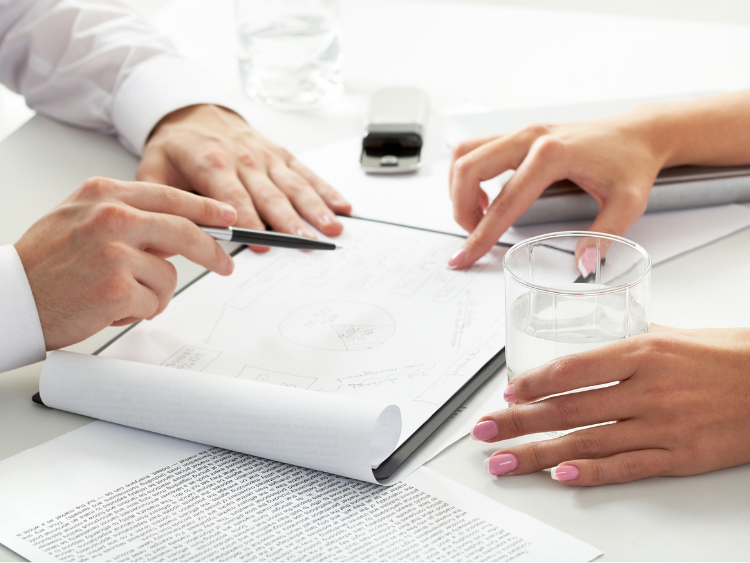 A man and a woman are completing a deal with a friendly handshake.