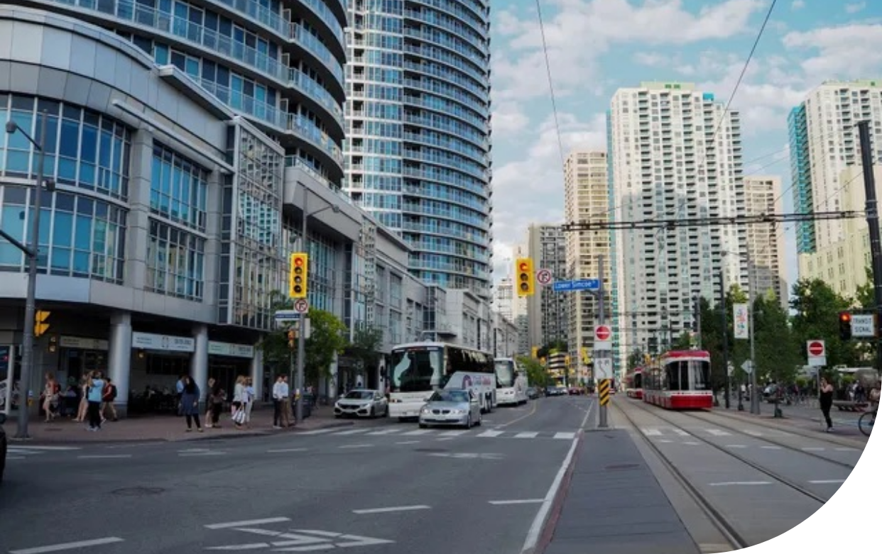 A city street with a lot of traffic and buildings in the background.