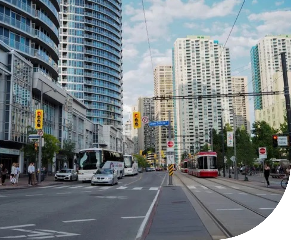 A busy city street surrounded by tall commercial buildings.