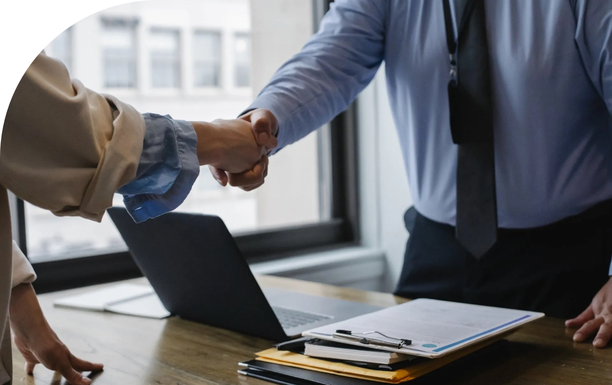 A man and a woman are completing a deal with a friendly handshake.