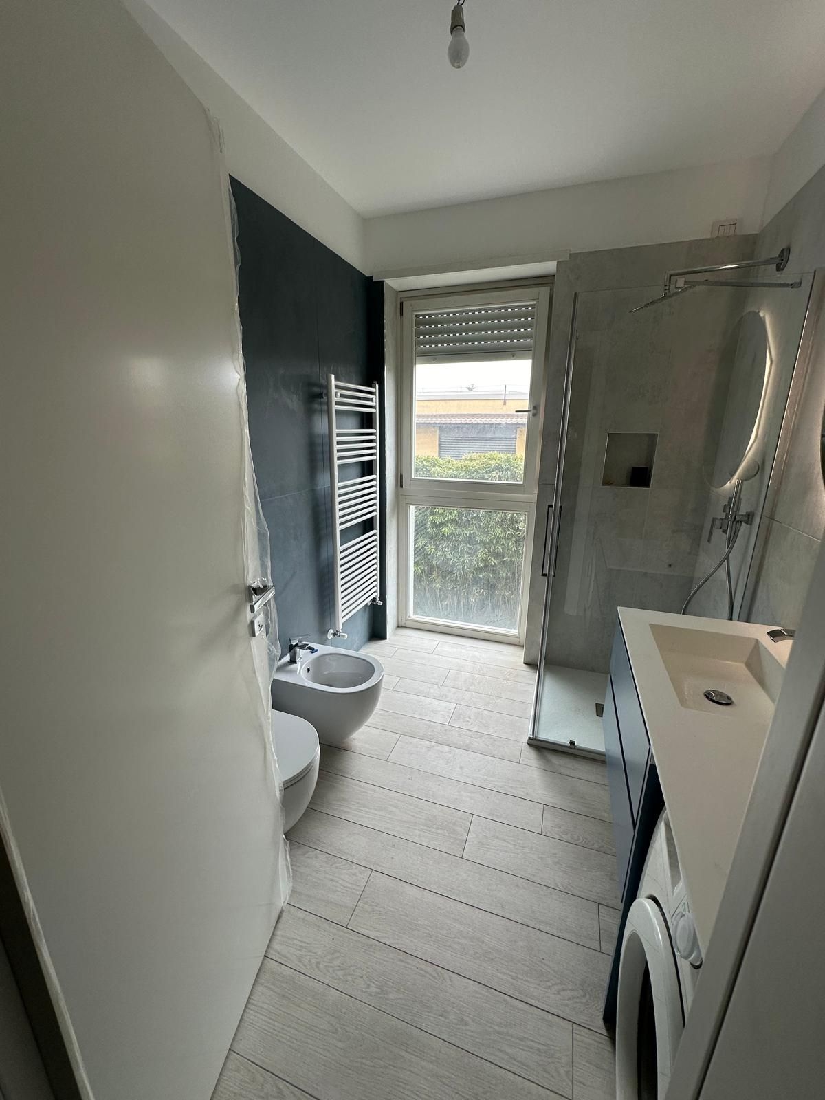 Un bagno con wc, lavandino e doccia.