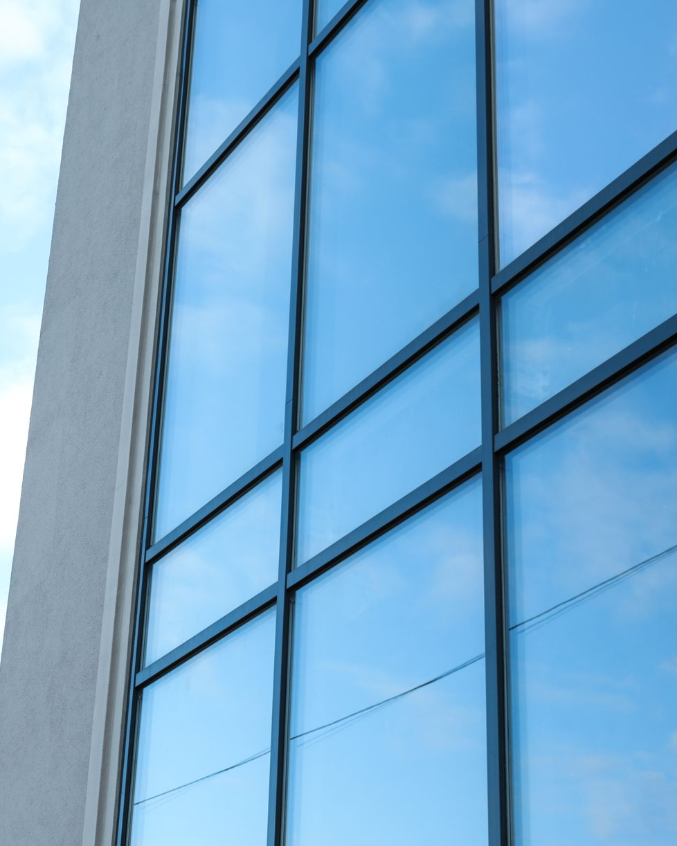 A man is cleaning the wheel of a black car with a sponge.