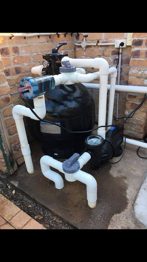 A Swimming Pool Filter And Pump Are Sitting On The Ground — Landsborough Pool Supplies & Service in Landsborough, QLD