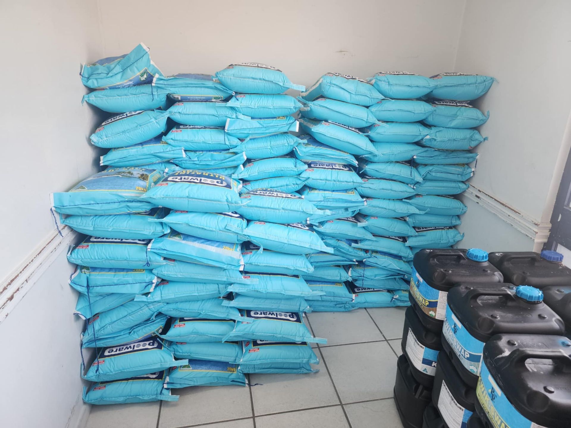 A Pile Of Blue Bags Stacked On Top Of Each Other In A Room — Landsborough Pool Supplies & Service in Landsborough, QLD