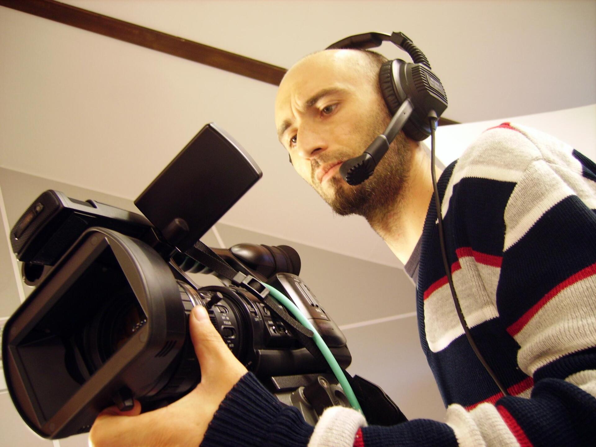 man holding the camera with headset