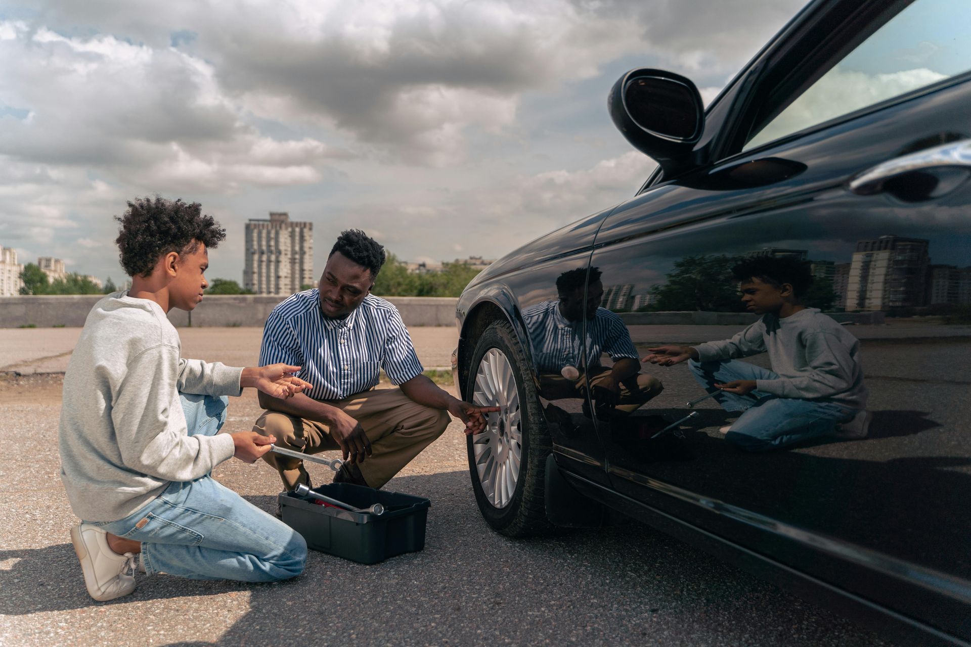 A family is laying on the grass in front of their house.