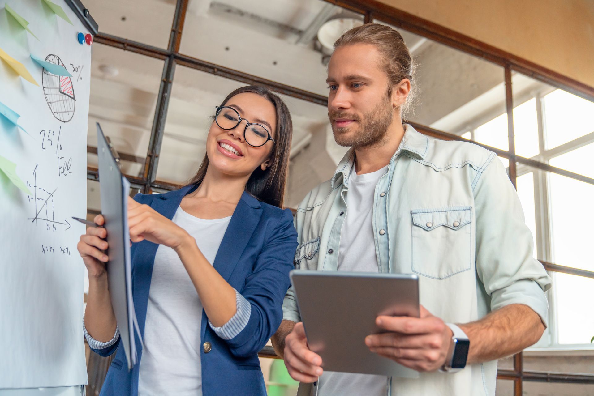 A family is laying on the grass in front of their house.