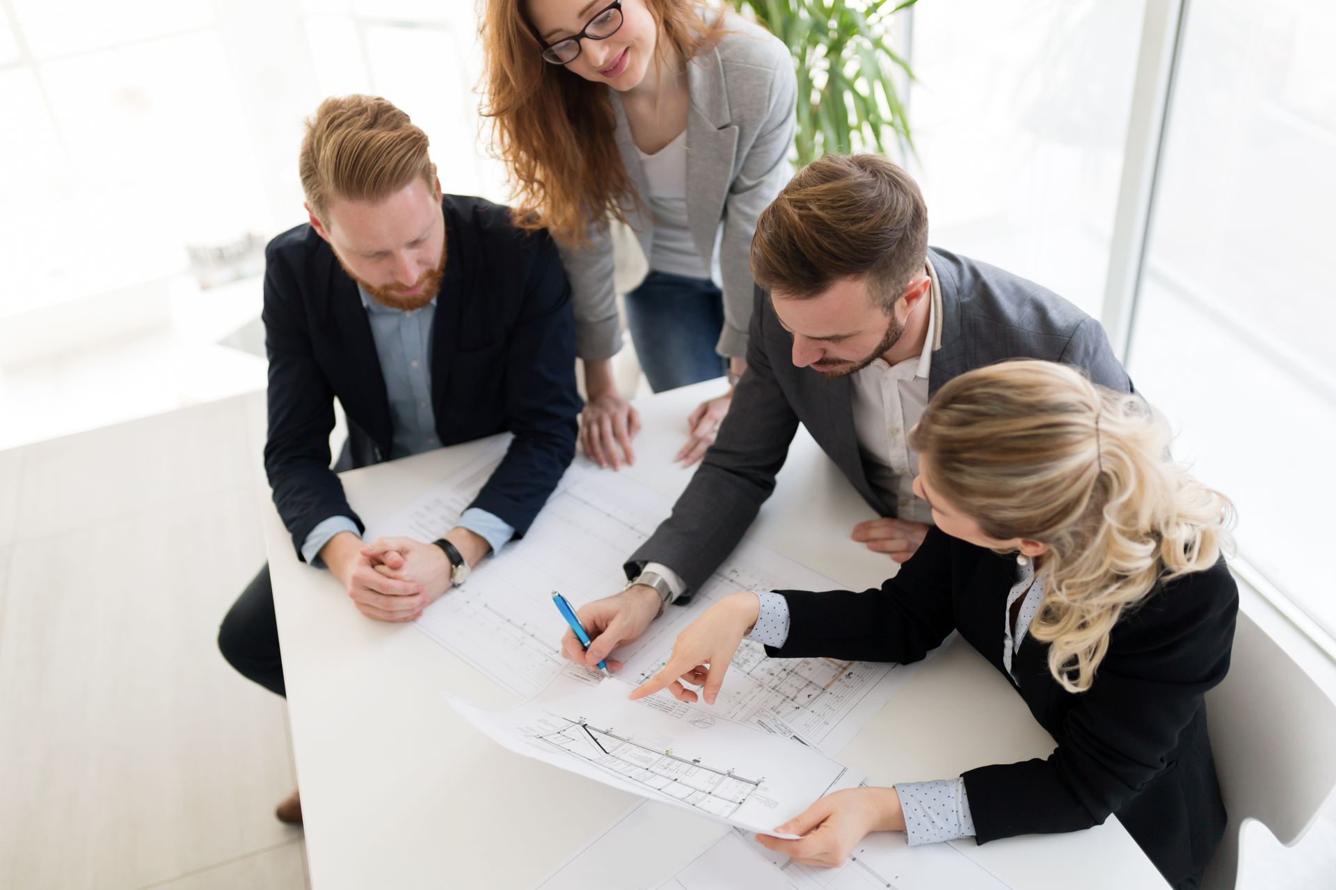 A family is posing for a picture in front of their new home.