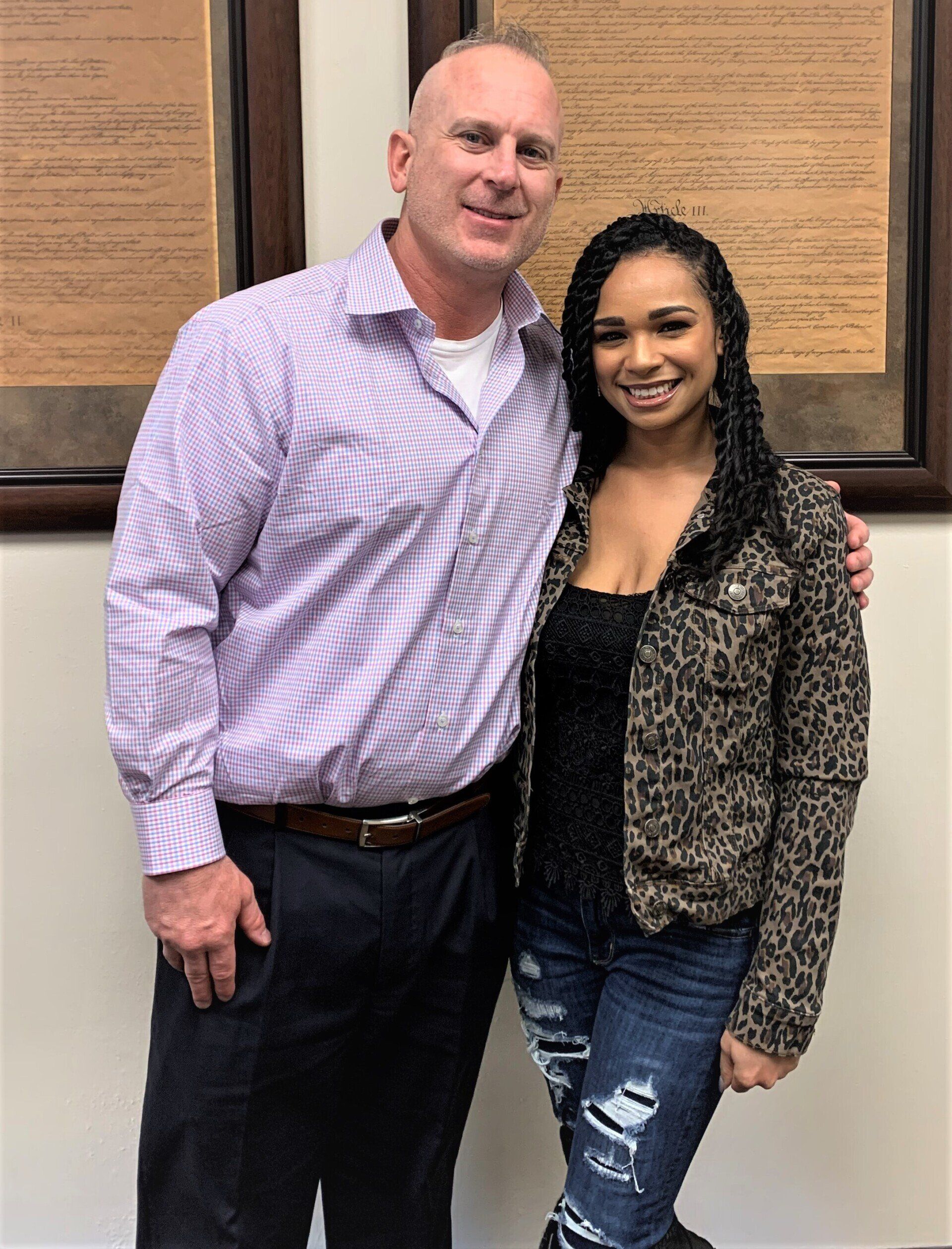 A man and a woman are posing for a picture.