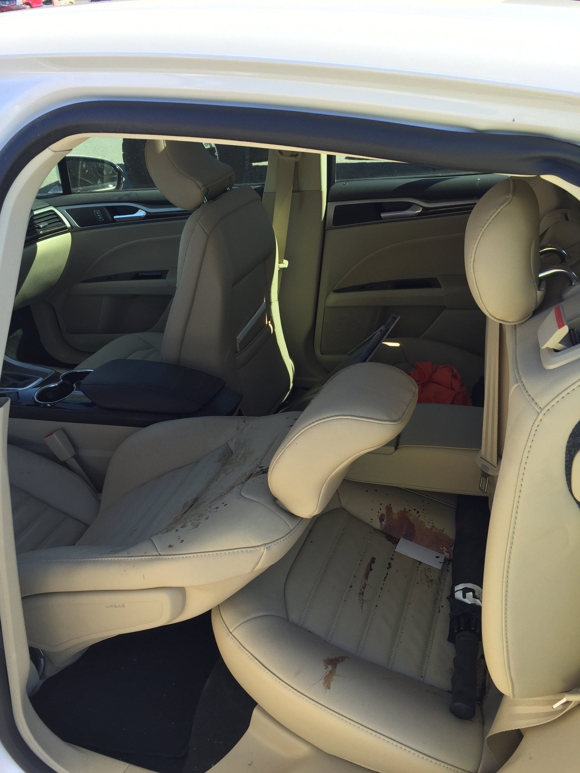 The inside of a white car with tan leather seats