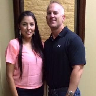 A man and a woman are posing for a picture together