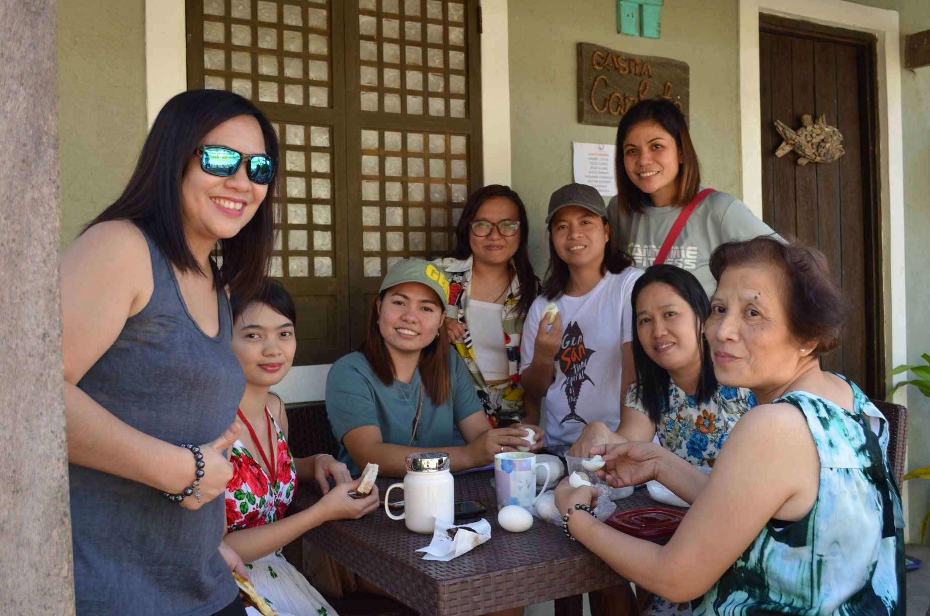 A group of women are sitting around a table.