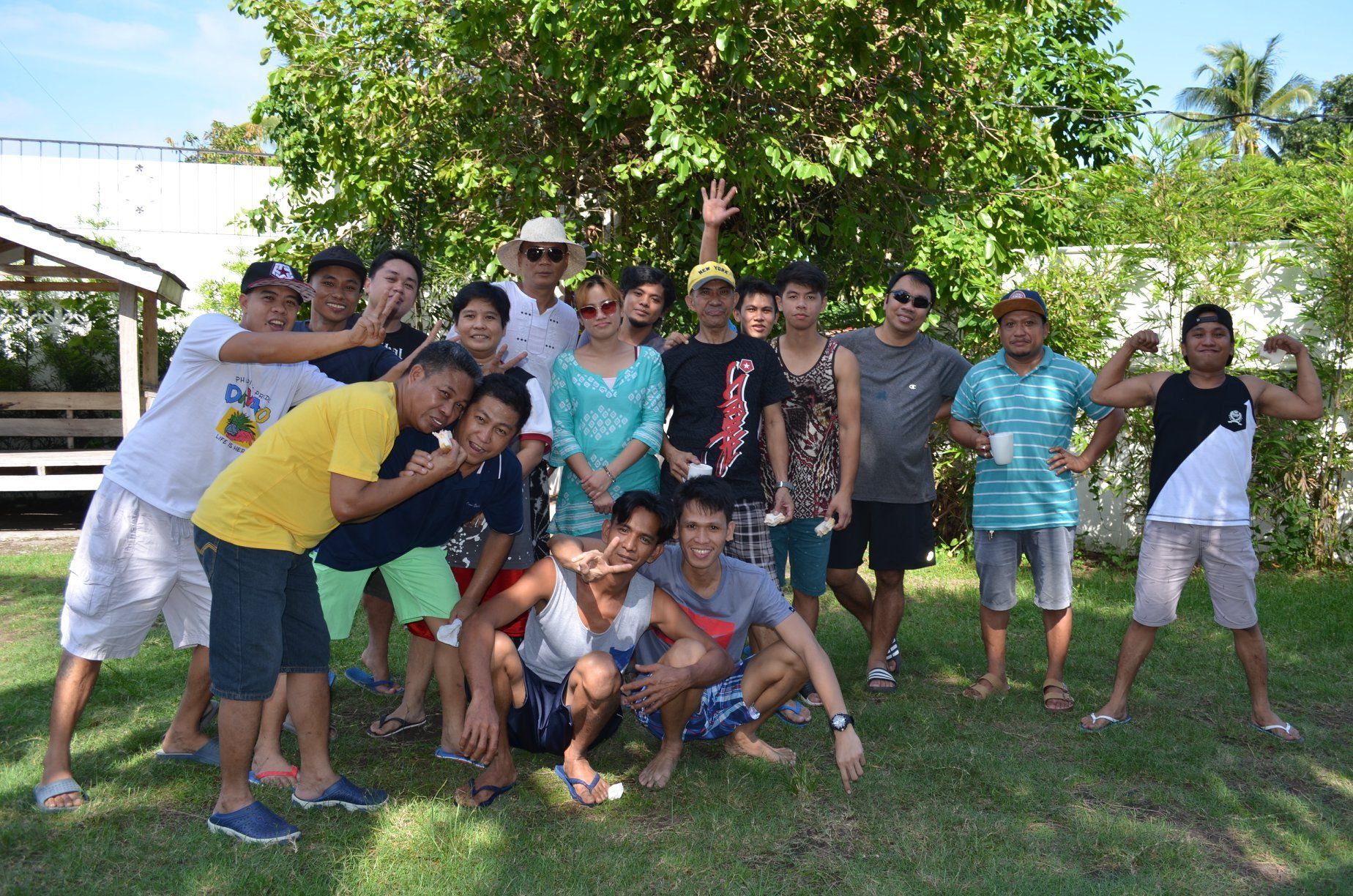 A group of people are posing for a picture in the grass.