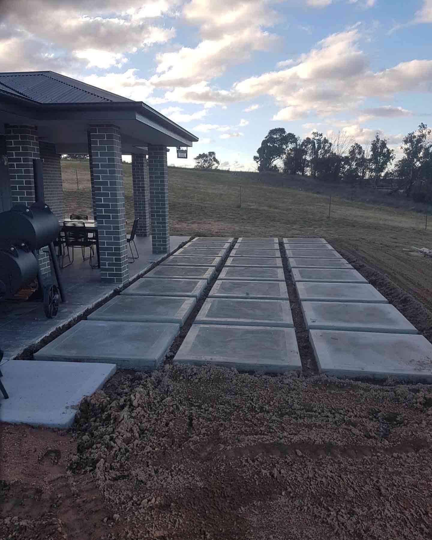 A Concrete Walkway Is Being Built In Front Of A House — Regional Concreting Solutions In Orange, NSW