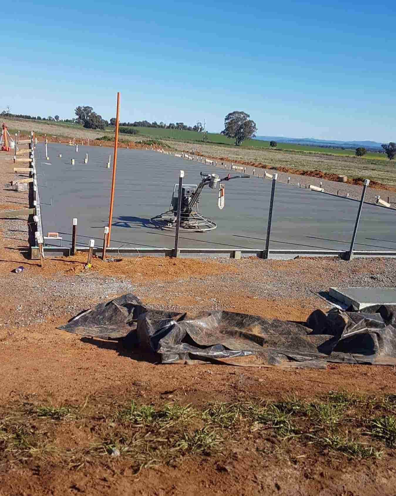 A Large Concrete Slab Is Being Poured In A Field — Regional Concreting Solutions In Blayney, NSW