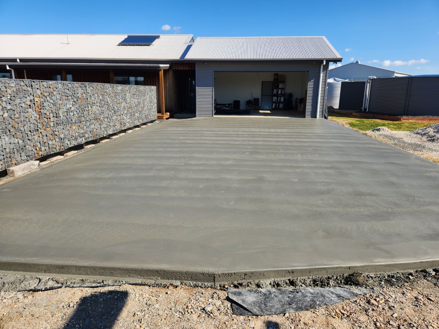 A Close Up Of A Concrete Pump Pouring Concrete On A Construction Site — Regional Concreting Solutions In Molong, NSW
